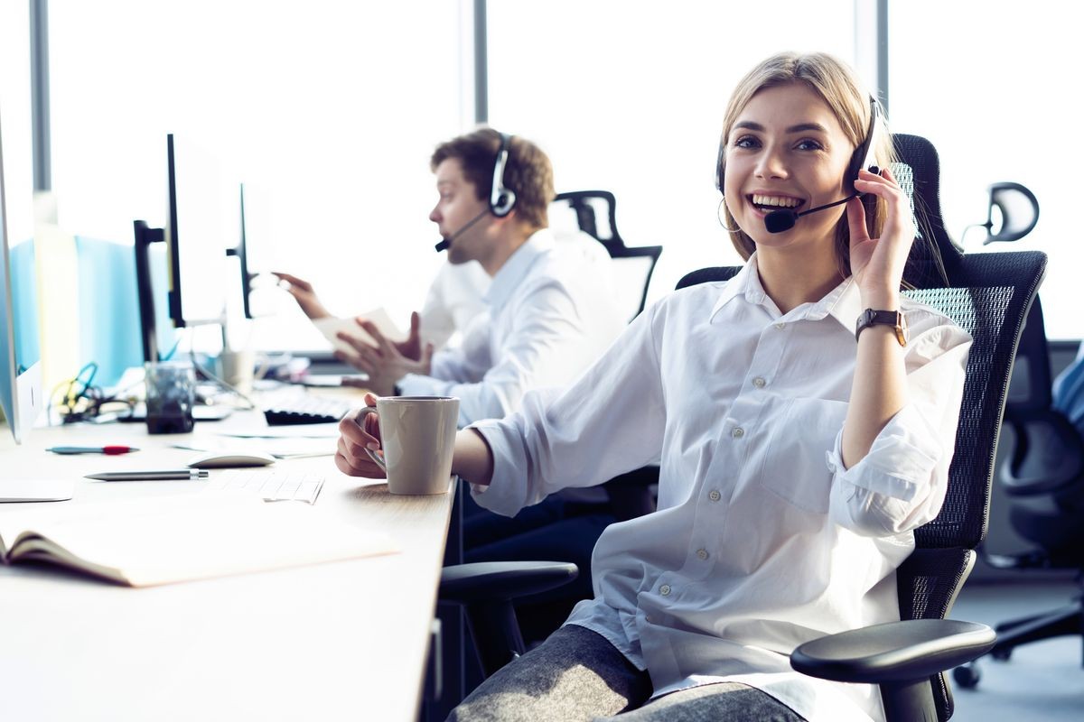 How can I help you? Female customer support operator with headset and smiling
